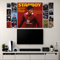 A large Cristiano Ronaldo 'Starboy' poster in a red and yellow design is displayed on a light gray wall above a black TV and a white media console with various home decor items.